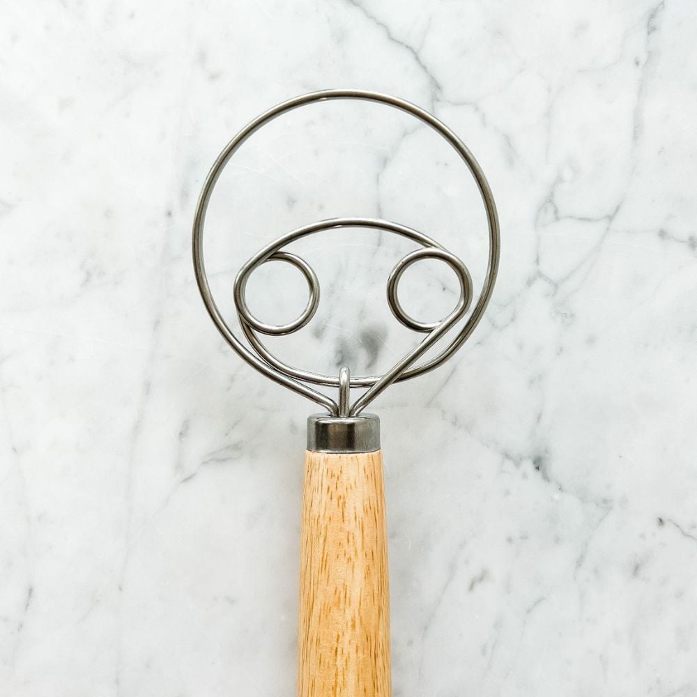 danish dough whisk with two eyes on marble