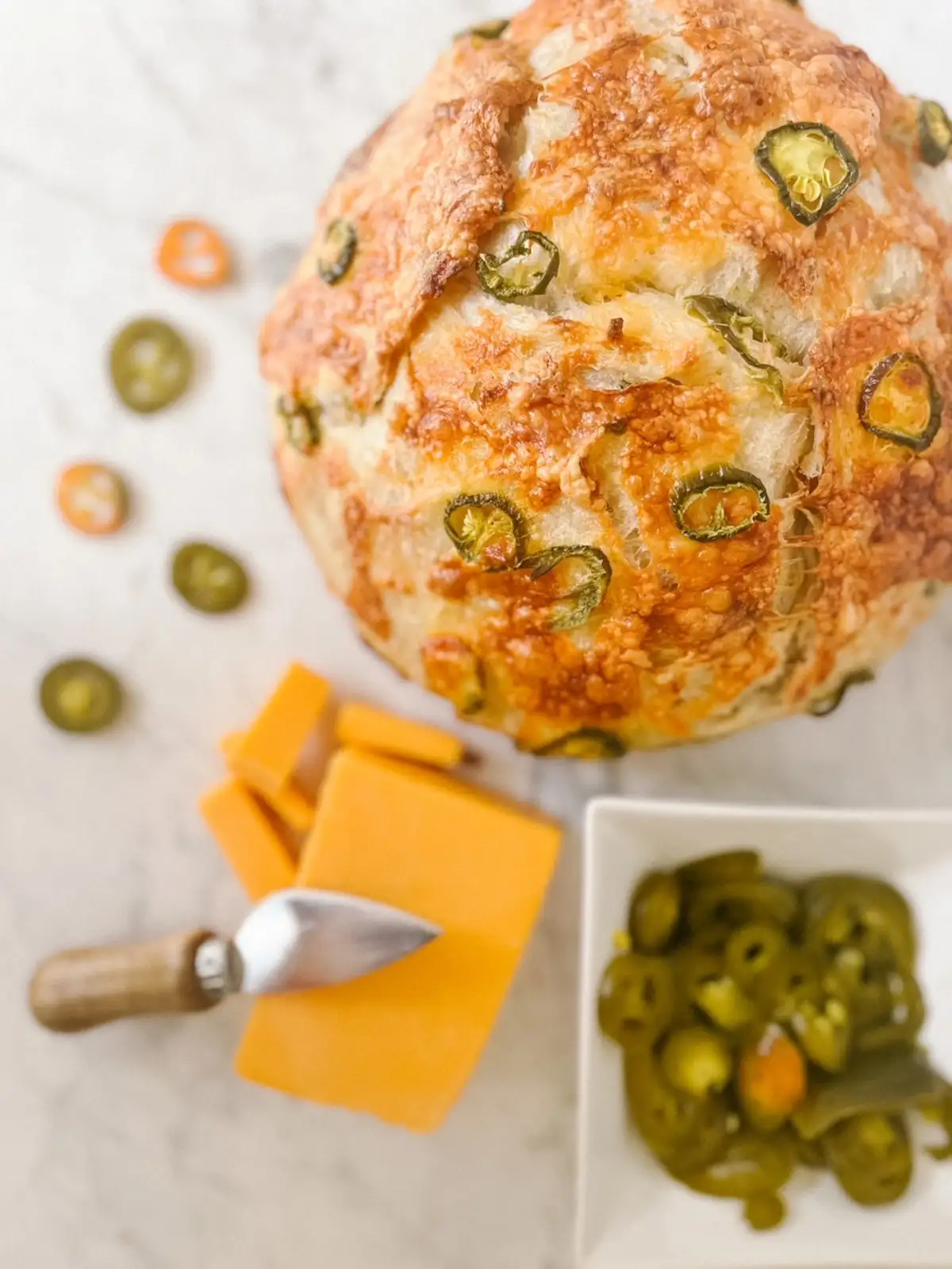 jalapenos and diced cheese with a jalapeno cheddar sourdough loaf