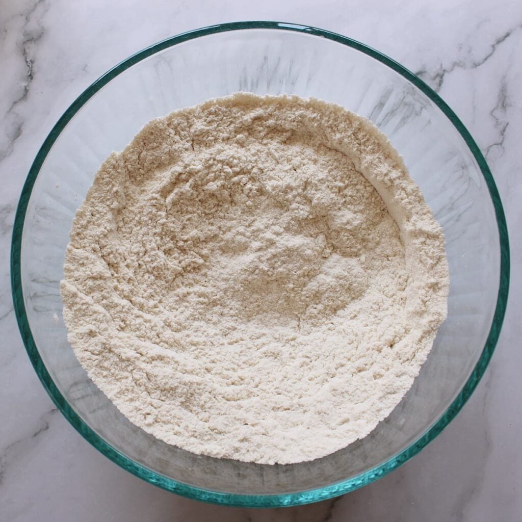 Dry ingredients for Sourdough Discard Pancakes mixed together in a clear bowl.