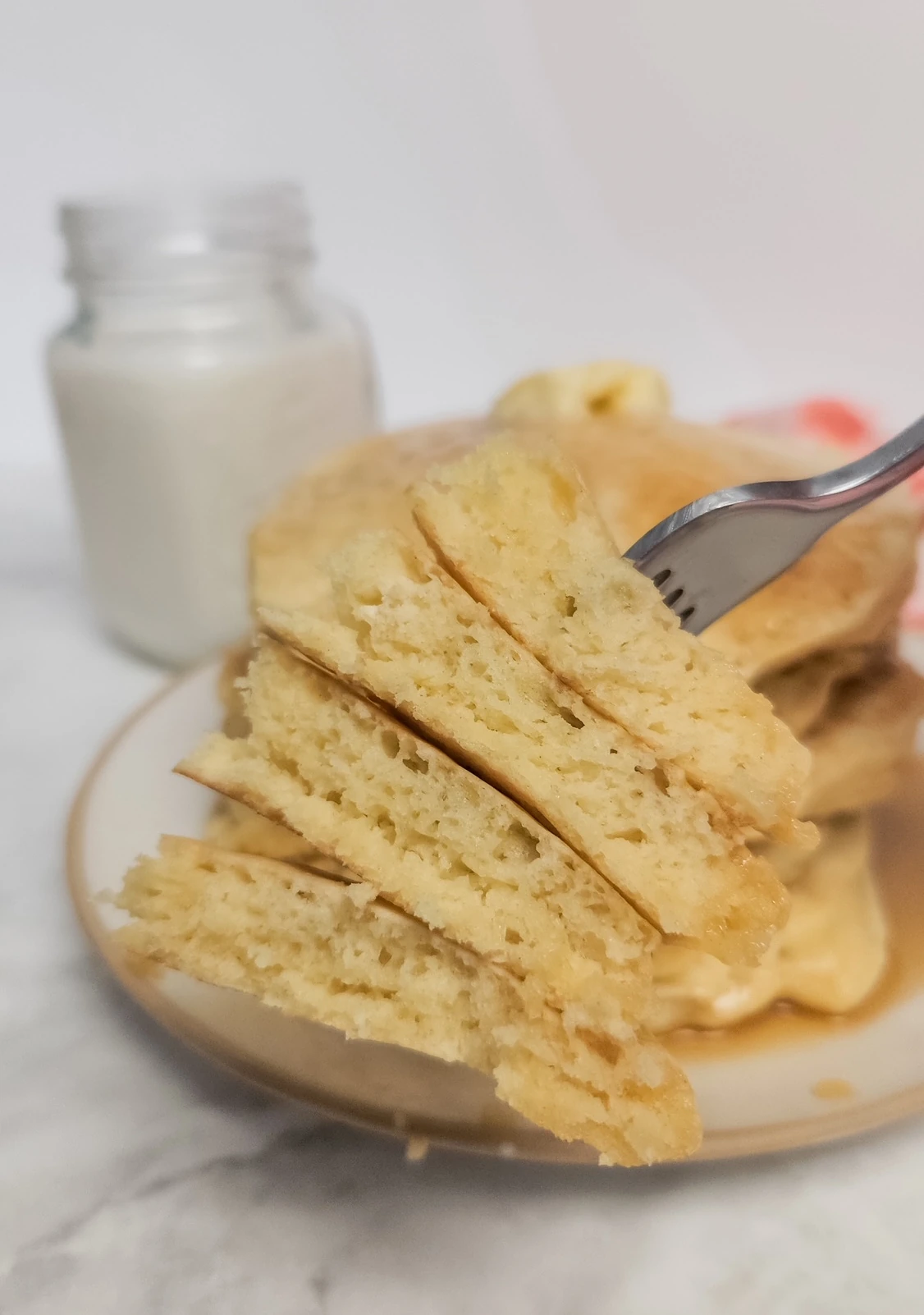 a stack of 4 pieces of sourdough pancakes on a fork