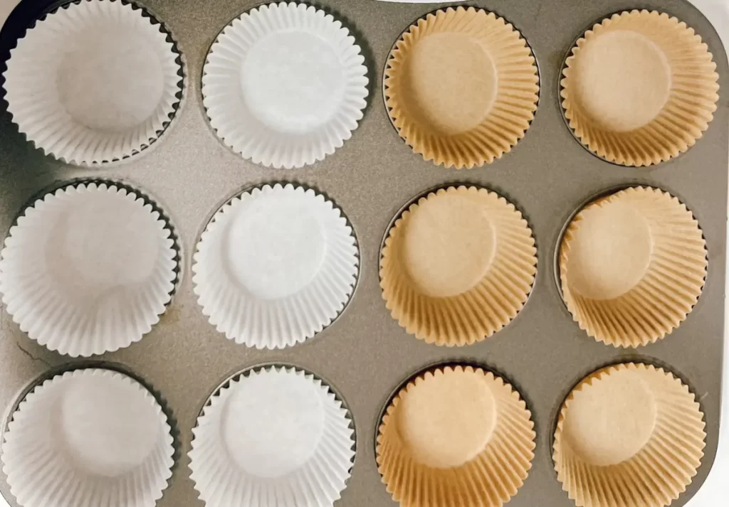 liners being added to a muffin pan