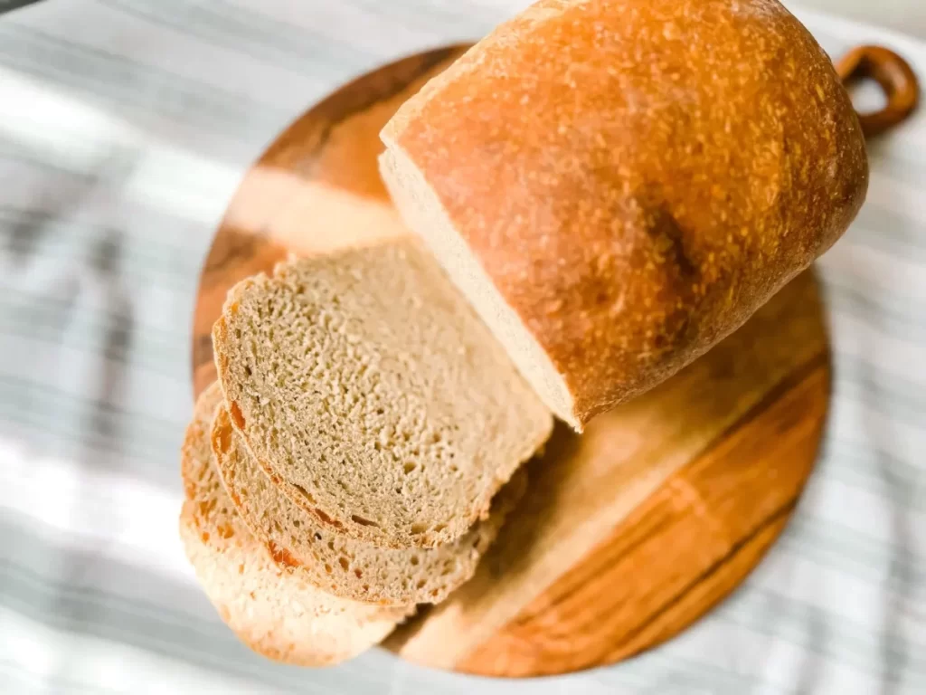 sliced sourdough sandwich bread on a round serving board