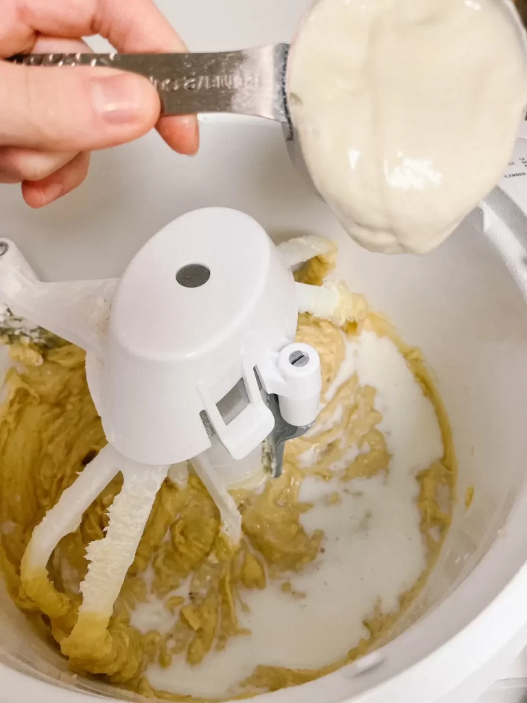 sourdough discard being added to sourdough banana muffins