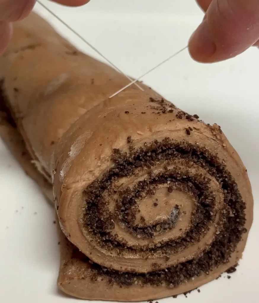 cutting a chocolate roll with floss