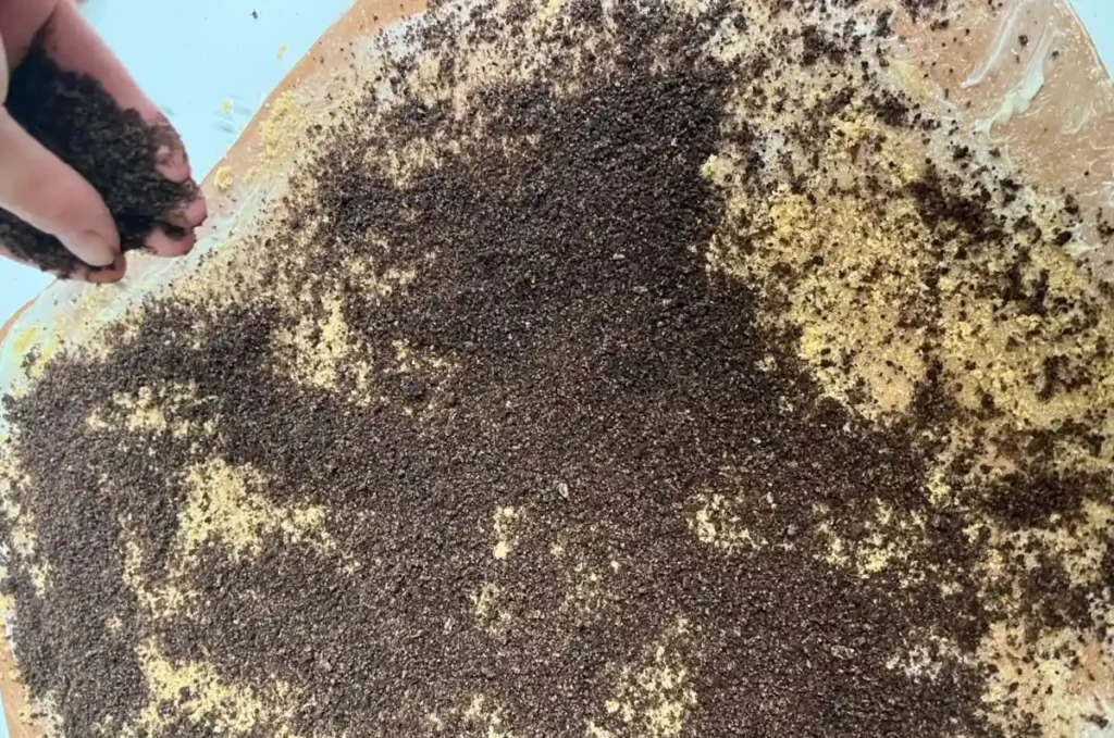 oreos being sprinkled over top the chocolate rolls