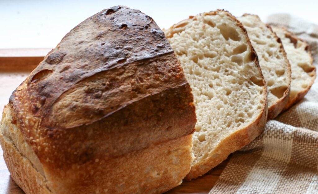 cut up sourdough bread in a loaf shape
