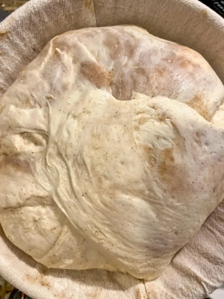 cinnamon honey butter sourdough bread dough in a round proofing basket