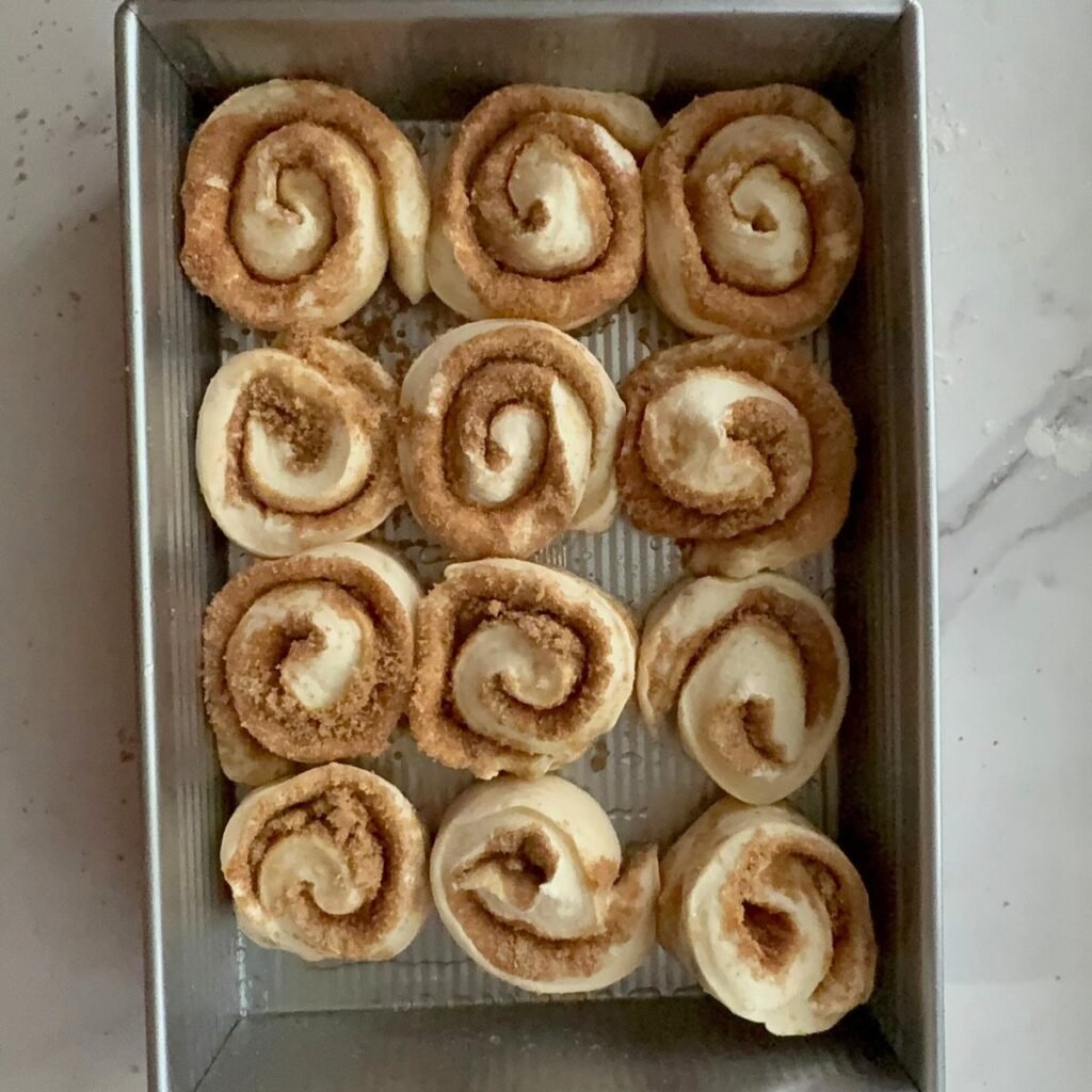 Sourdough cinnamon rolls before second rise in a 9x13 pan.