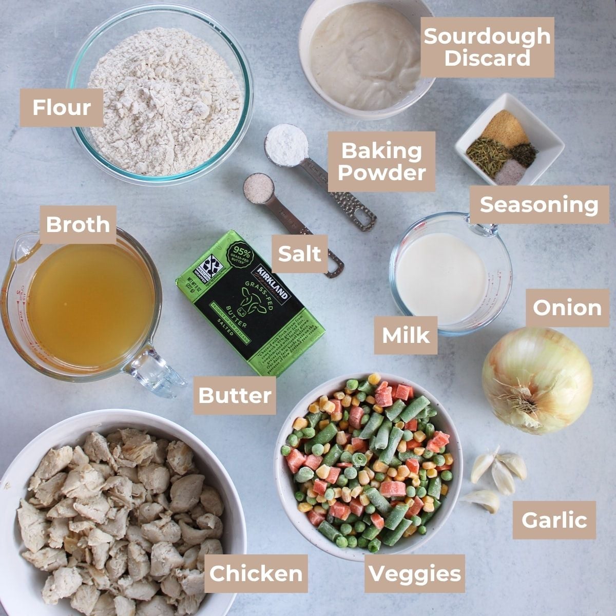Ingredients for sourdough pot pie in bowls on a white background. 