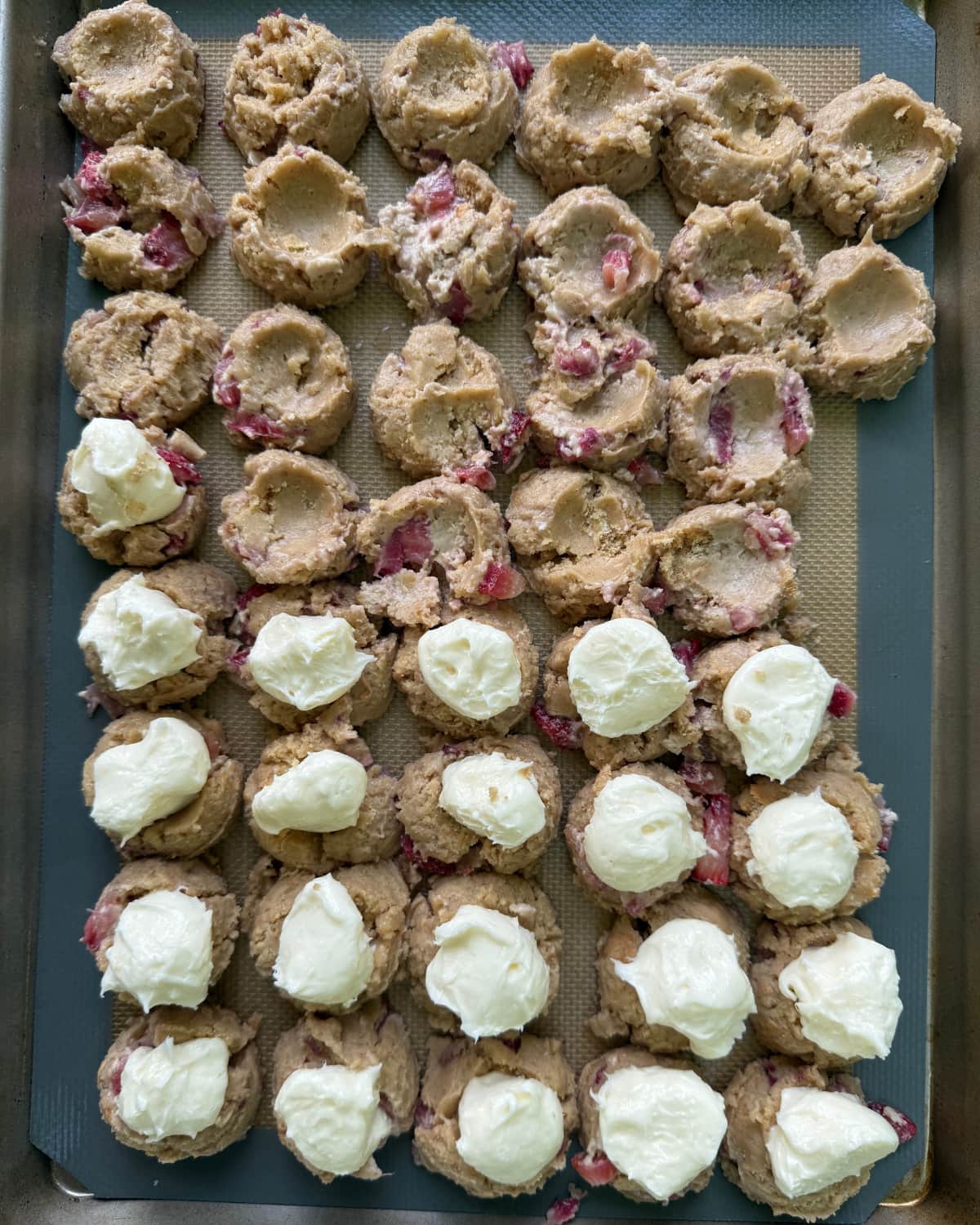 stuffing sourdough strawberry cookies with cheesecake filling.