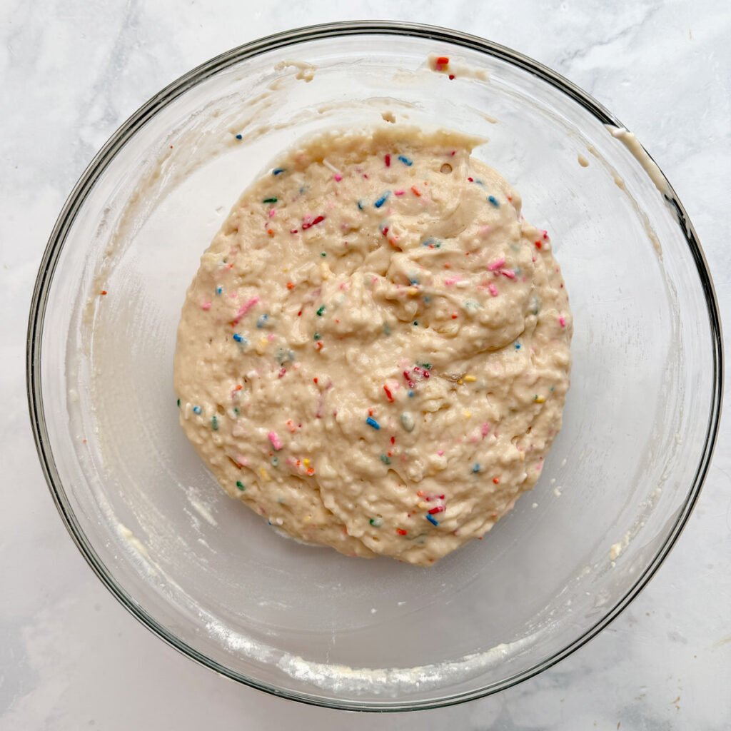 Batter for Sourdough Mini Muffins with sprinkles.