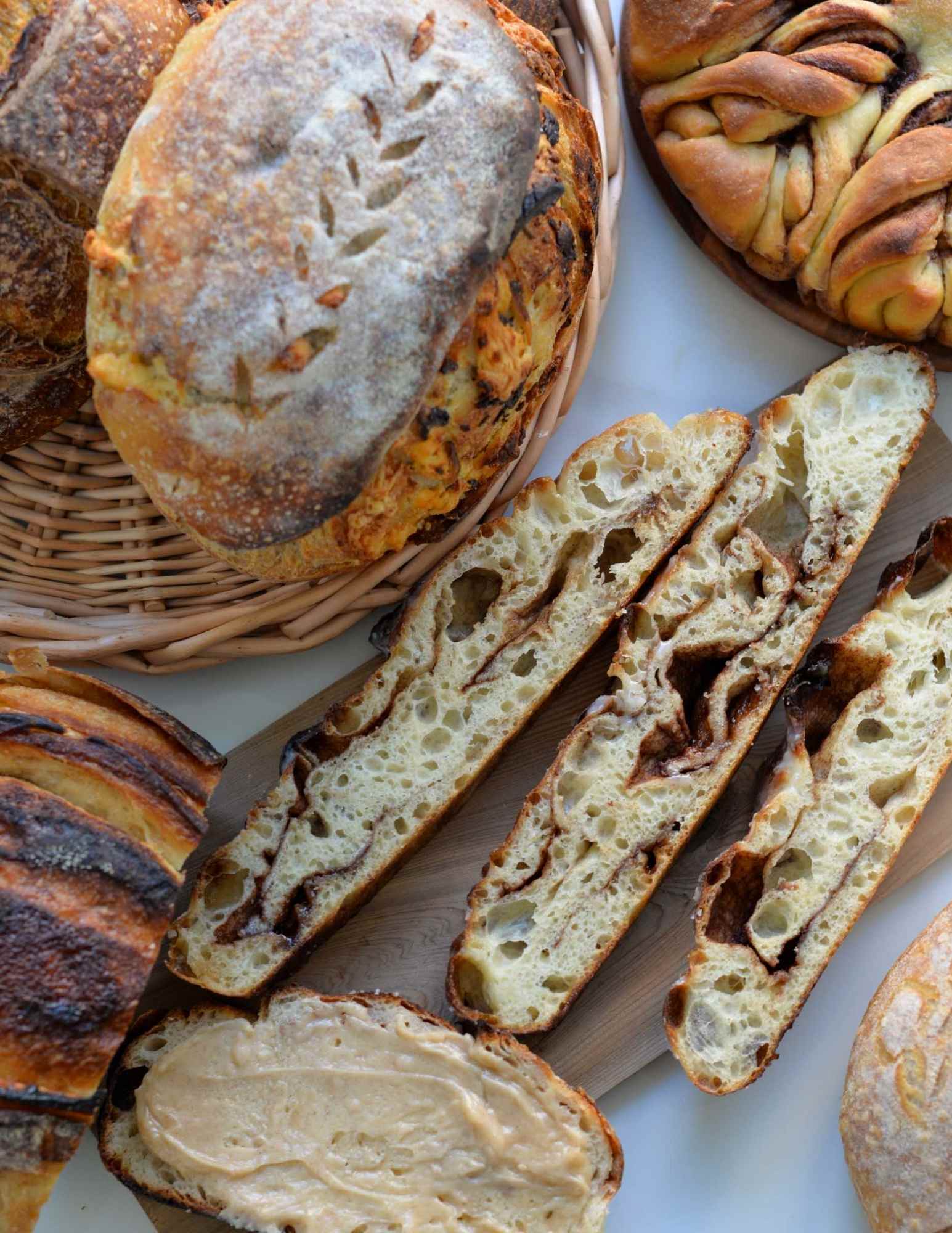 sourdough breads and focaccias on a table