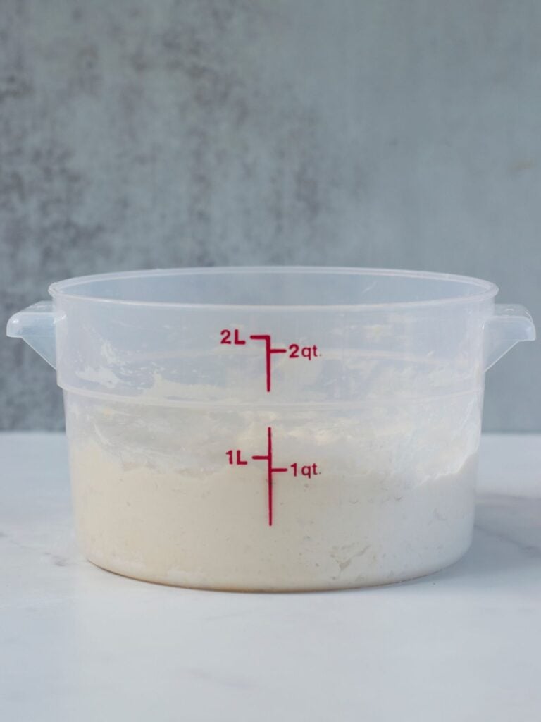 Shaggy dough for sourdough focaccia formed in a 2 quart container.