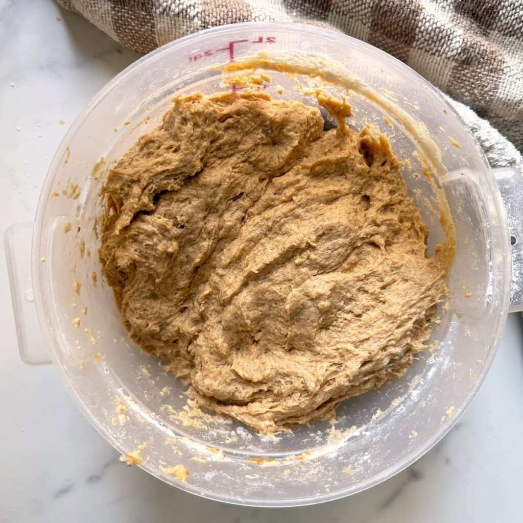 Sourdough pumpkin bread ingredients mixed together in a straight-edge bowl.