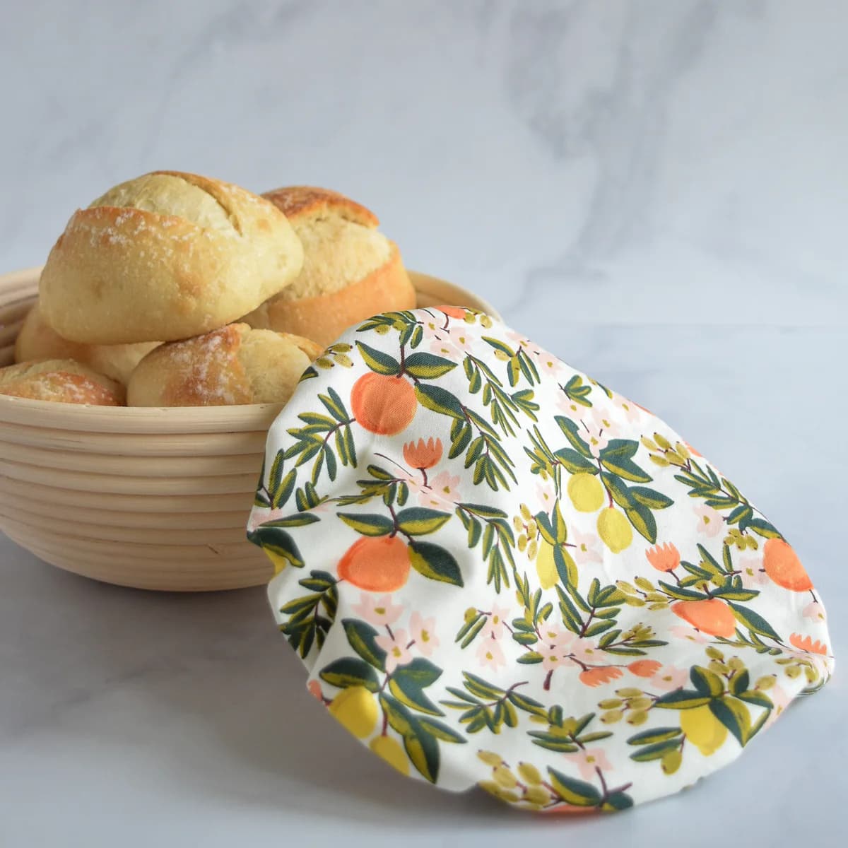 wild clementine proofing bowl cover over a banneton basket full fo bread. 