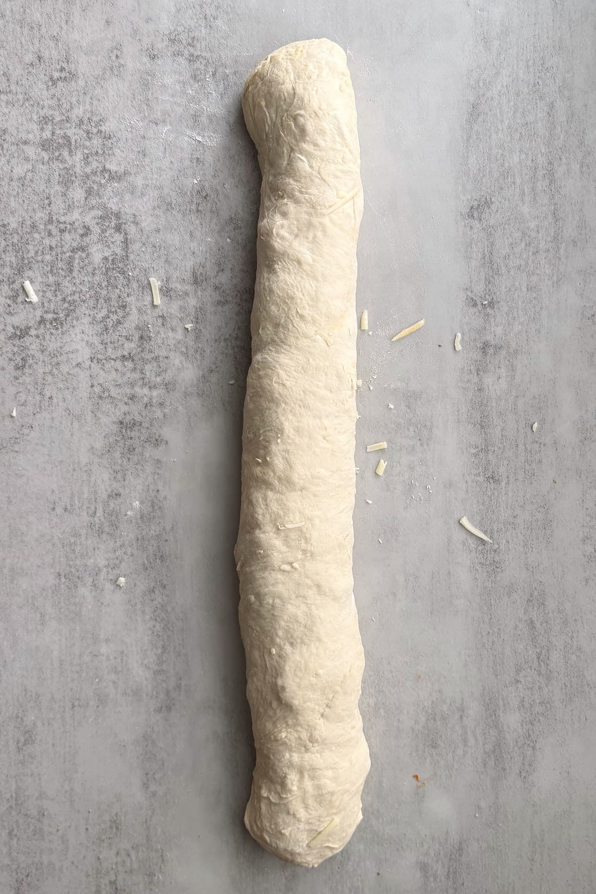 Sourdough pizza wreath dough rolled into a log.