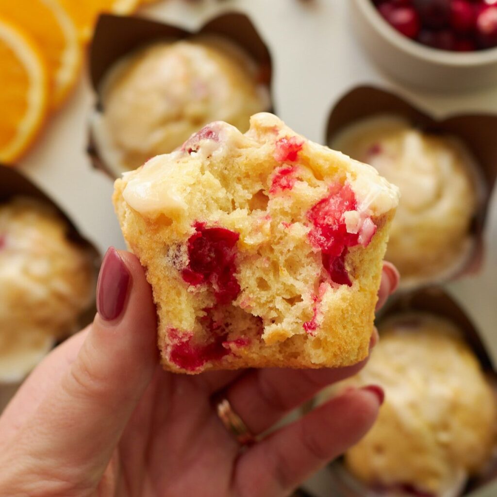 bite taken out of a cranberry orange muffin