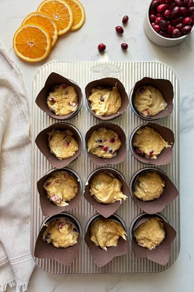 cranberry orange muffin matter divided in muffin tins