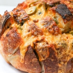 Close up on freshly baked Jalapeno Cheddar Pull Apart Sourdough Bread with melted cheese