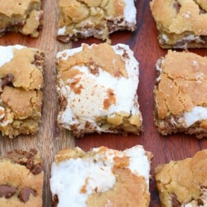S'mores sourdough cookie bars cut into squares on top of a wooden board.