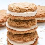Three Sourdough Oatmeal Cream Pies with brown butter frosting stacked on top of each other.