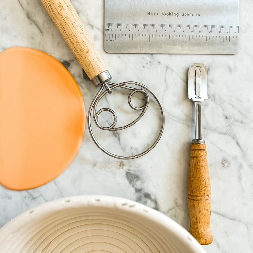 sourdough tools for sourdough baking on a white and black marbled background