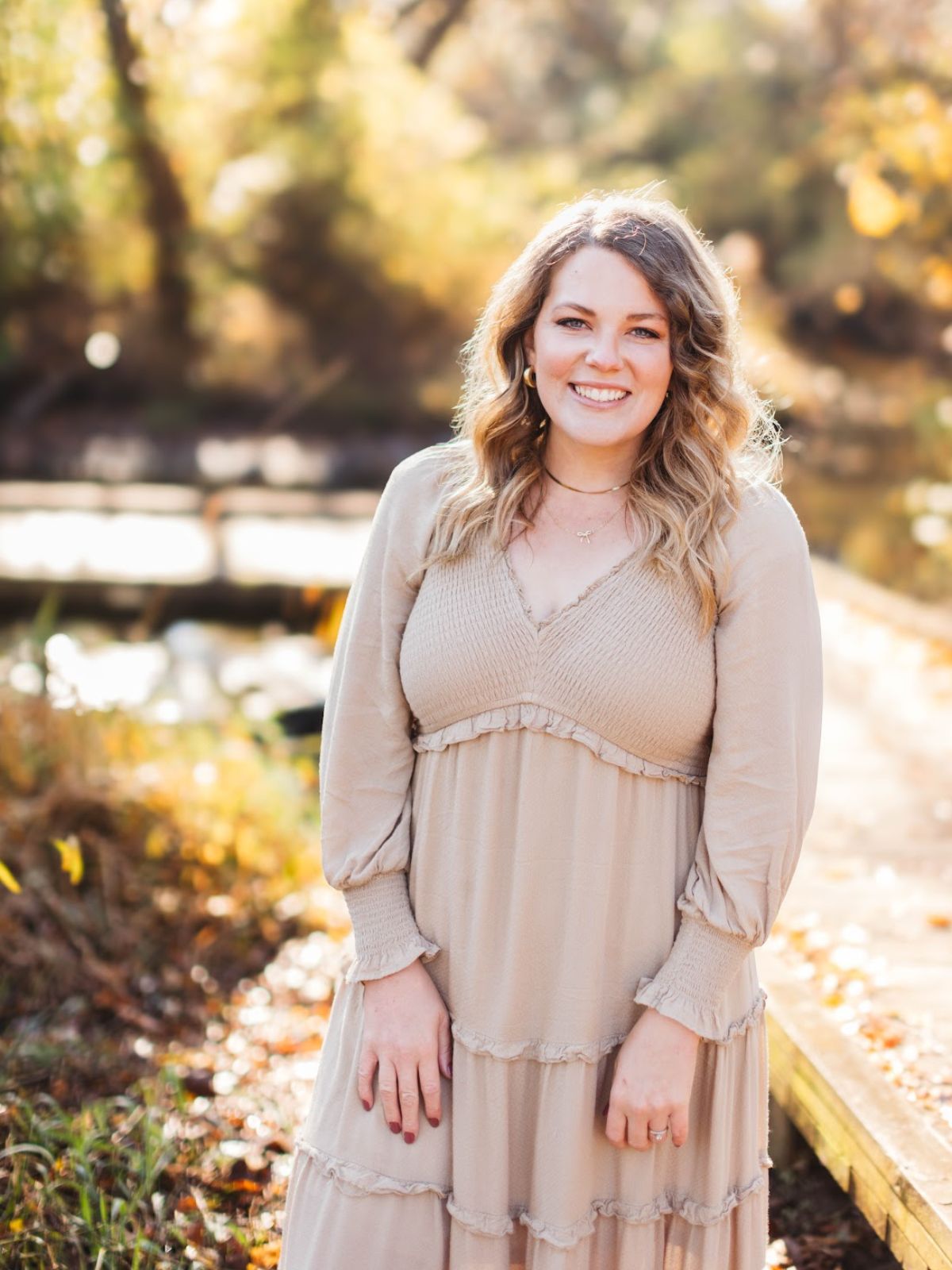 emily from country roads sourdough in the woods with a beige dress
