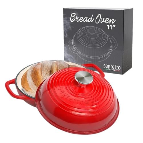 red bread oven with a loaf of bread baking inside. 