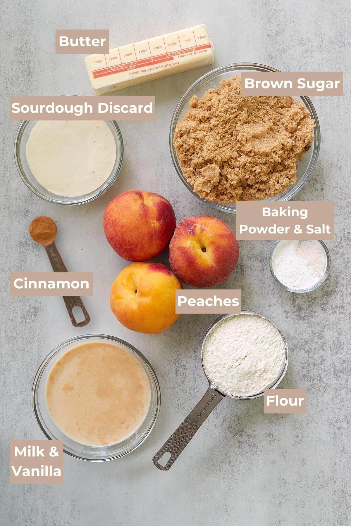 Ingredients for Sourdough Peach Cobbler on a grey background.
