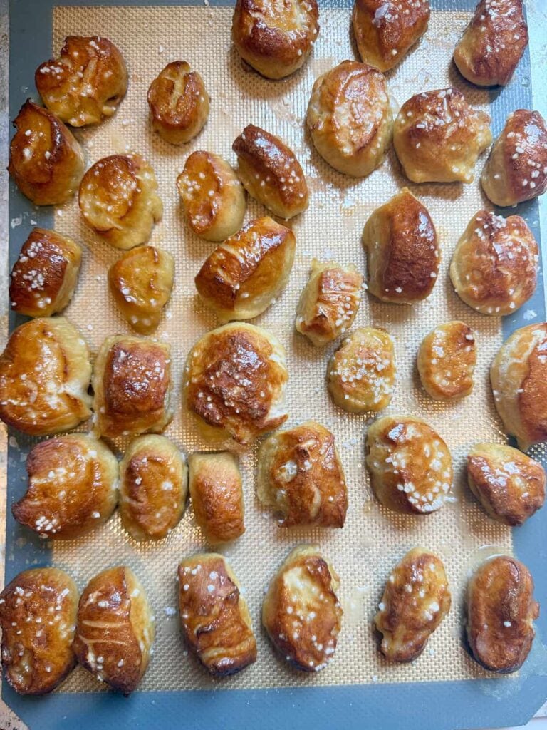 Freshly baked Sourdough Pretzel Bites on a sheet pan.