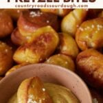 Sourdough Pretzel Bites with a small bowl of mustard and one pretzel bite dipped inside.