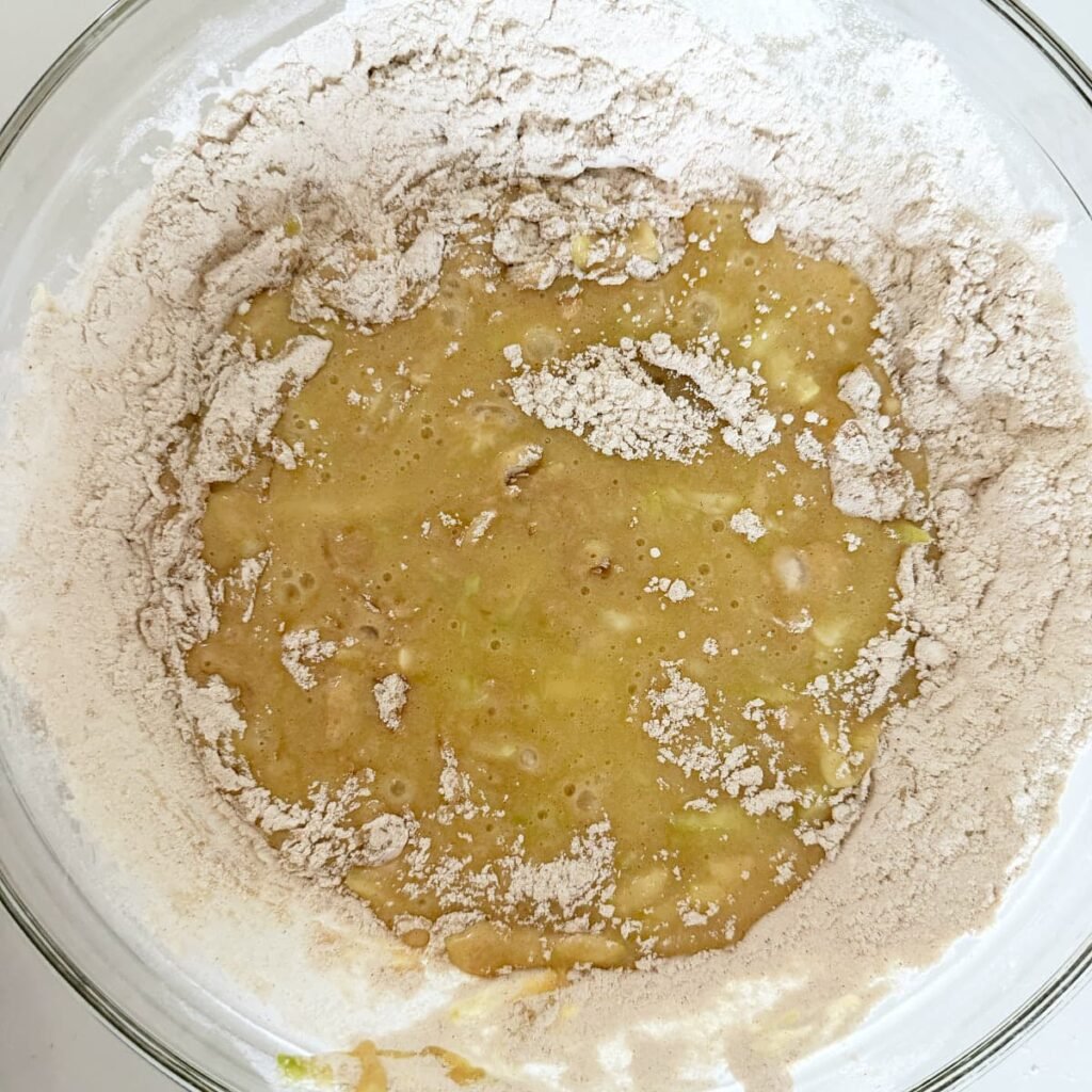 Dry ingredients added with the wet ingredients for Sourdough Zucchini Bread.