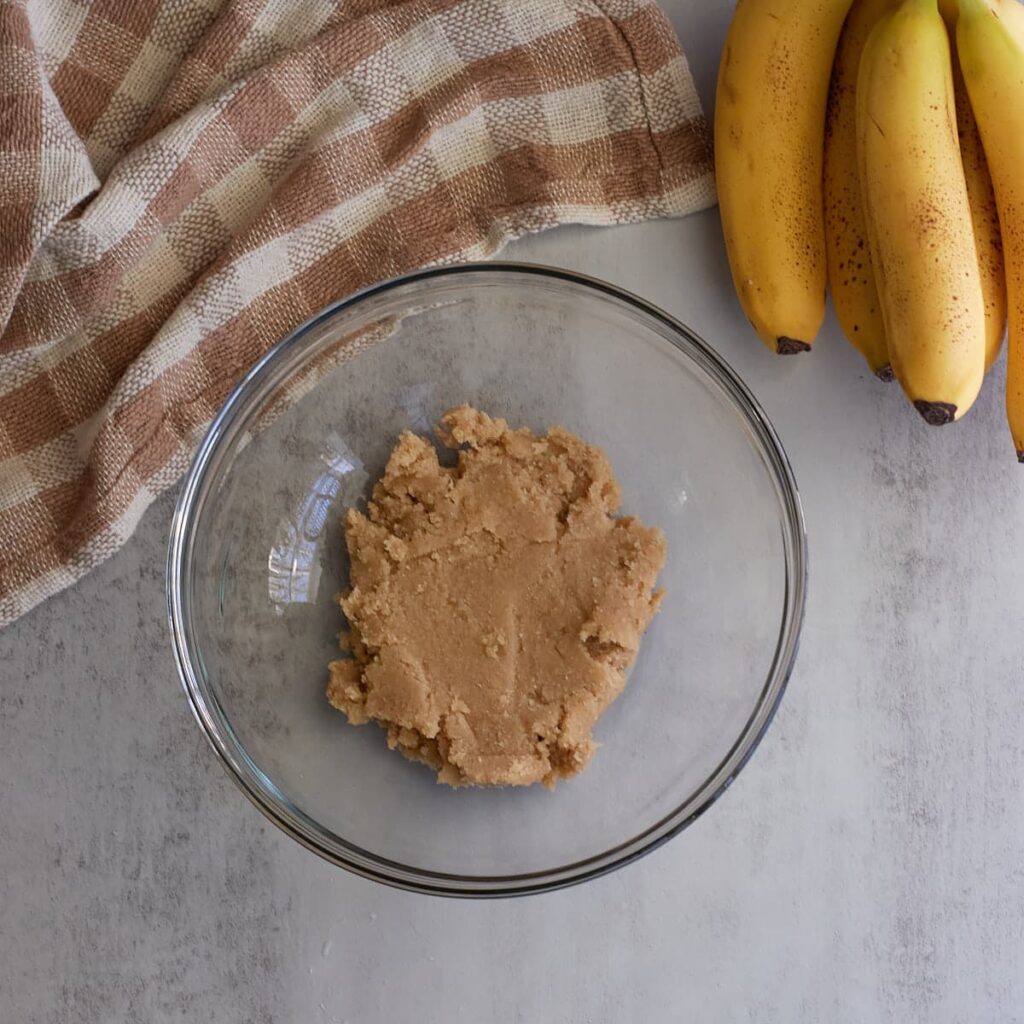 Butter and sugar creamed together in a clear bowl.