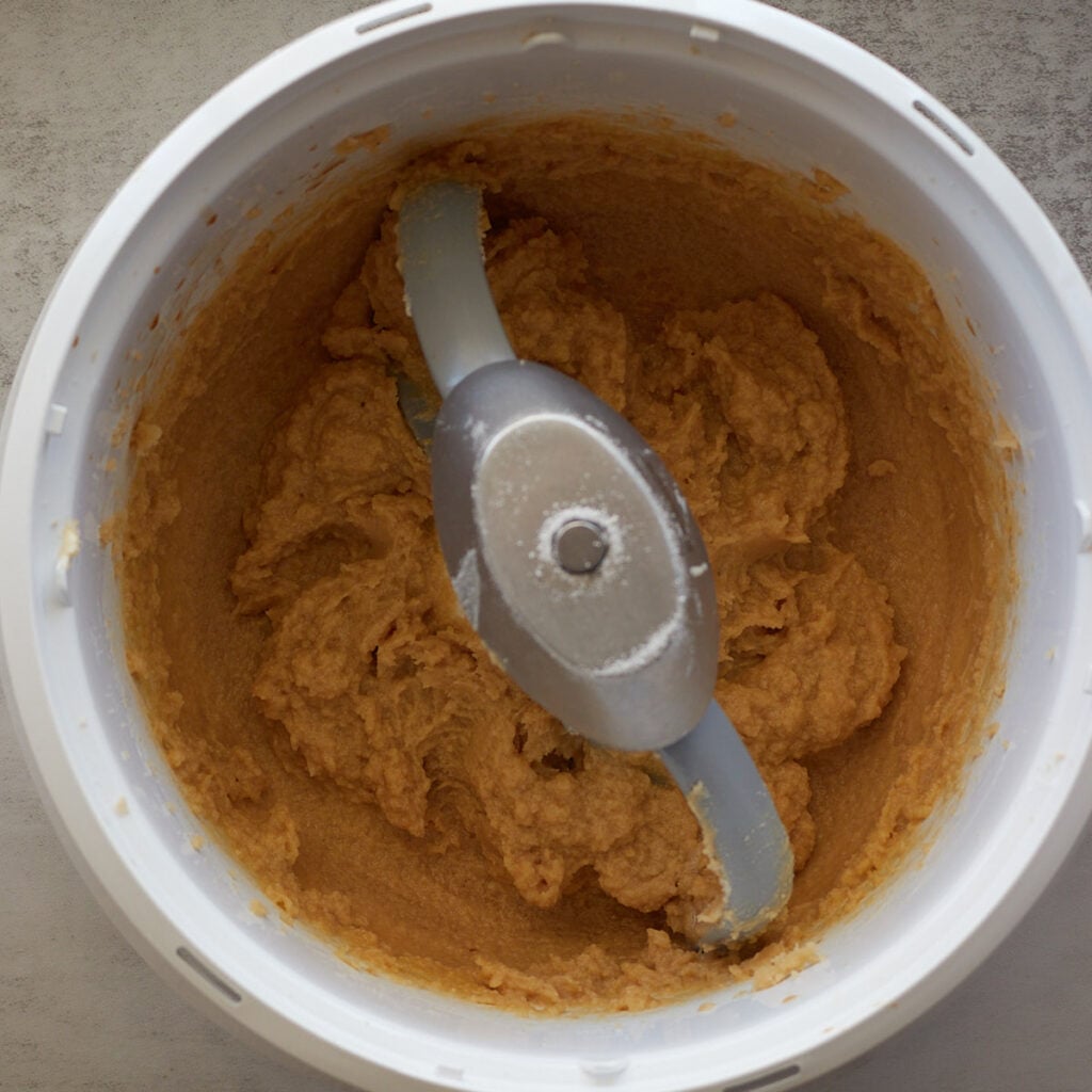 Wet ingredients added to creamed sugar and butter in a bosch mixer.