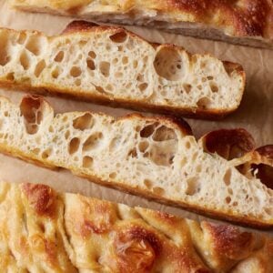 Inside view of sourdough focaccia sliced on top of parchment paper.