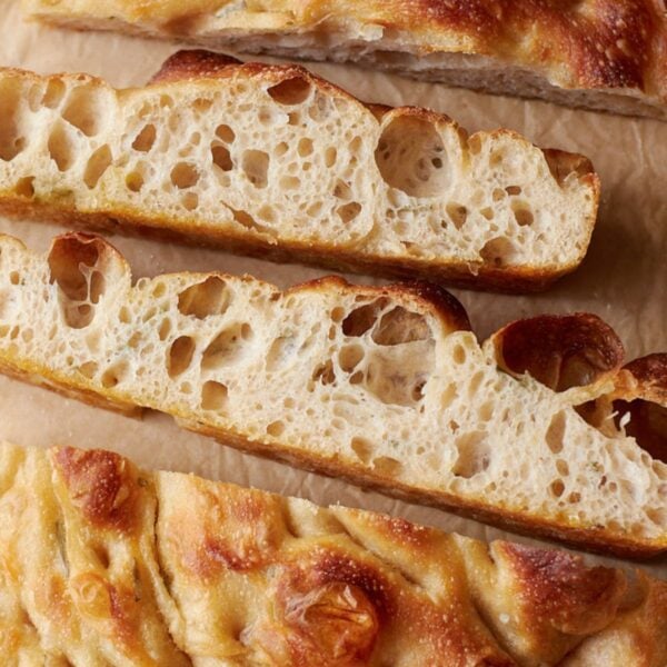 Inside view of sourdough focaccia sliced on top of parchment paper.