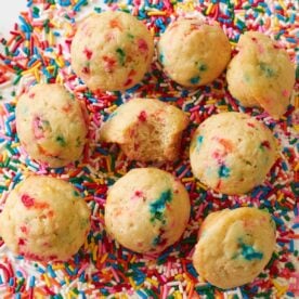 Sourdough Mini Muffins on a bed of rainbow sprinkles.