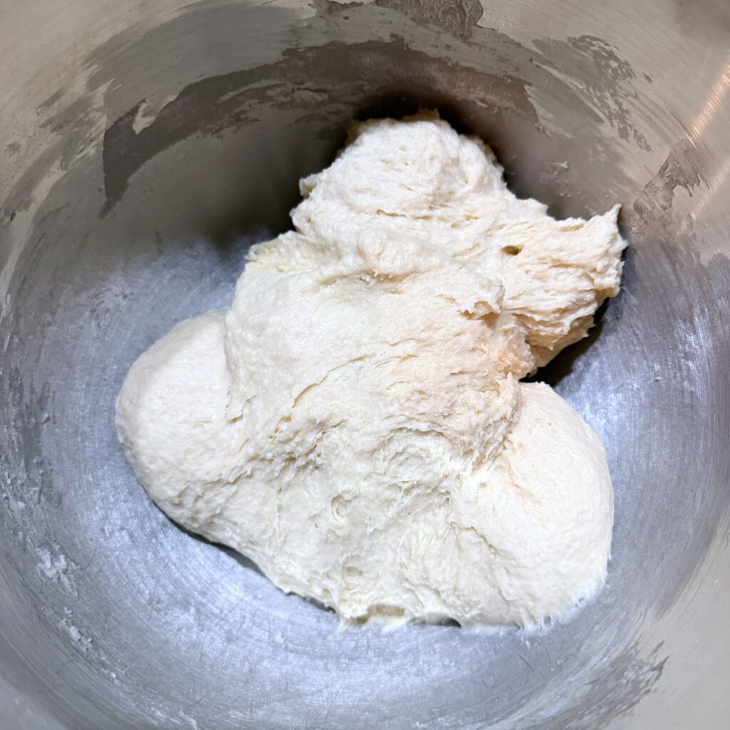 Sourdough cinnamon roll dough after being mixed in stand mixer.