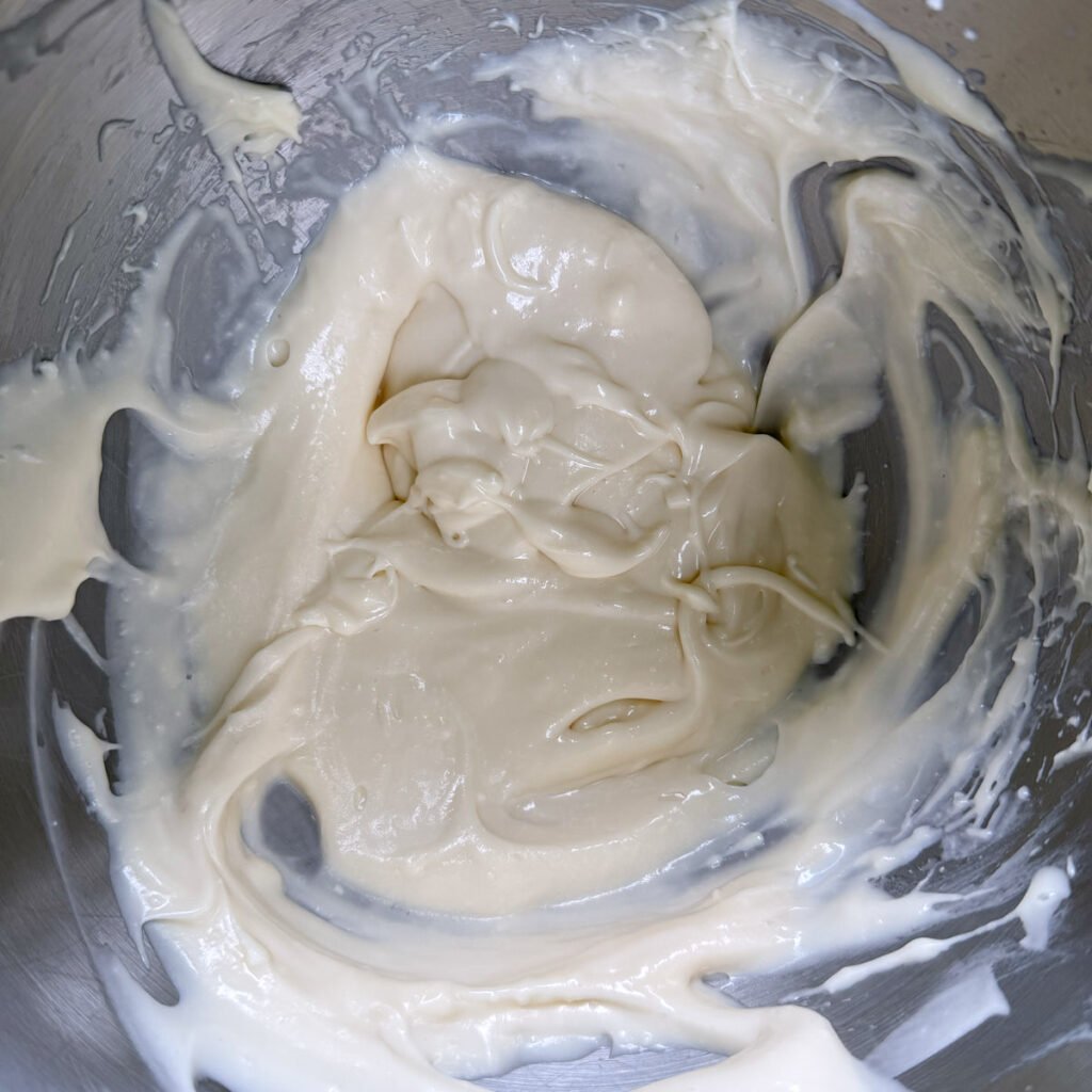 Cream cheese frosting in a mixing bowl.