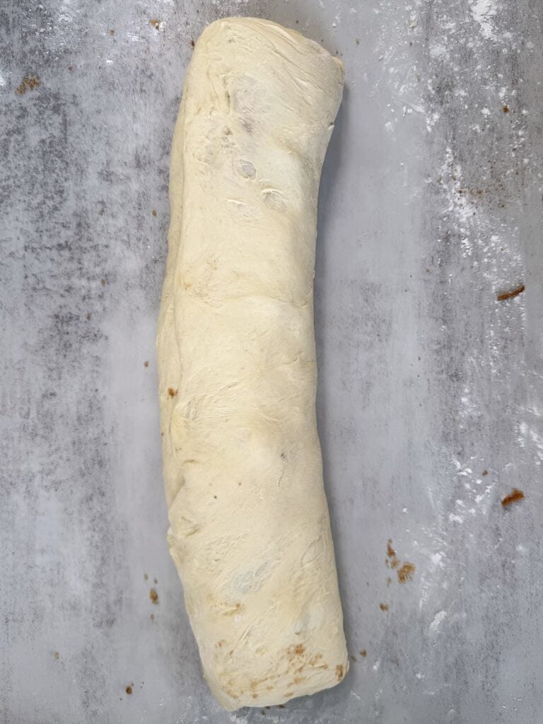 Cinnamon roll dough rolled into a log.