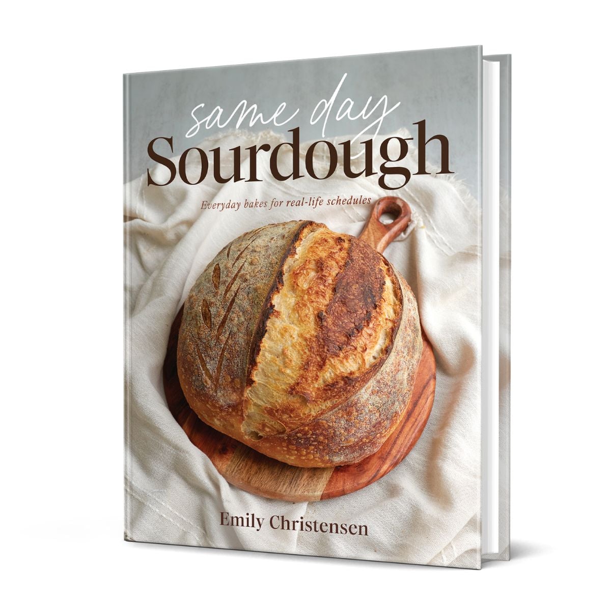 Cover for Same Day Sourdough Cookbook with a loaf of sourdough on a wooden board.