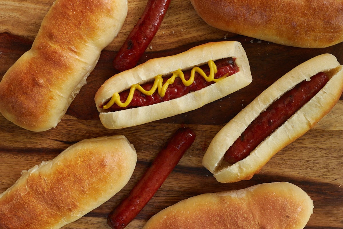 Hot dog with ketchup and mustard on a sourdough bun.