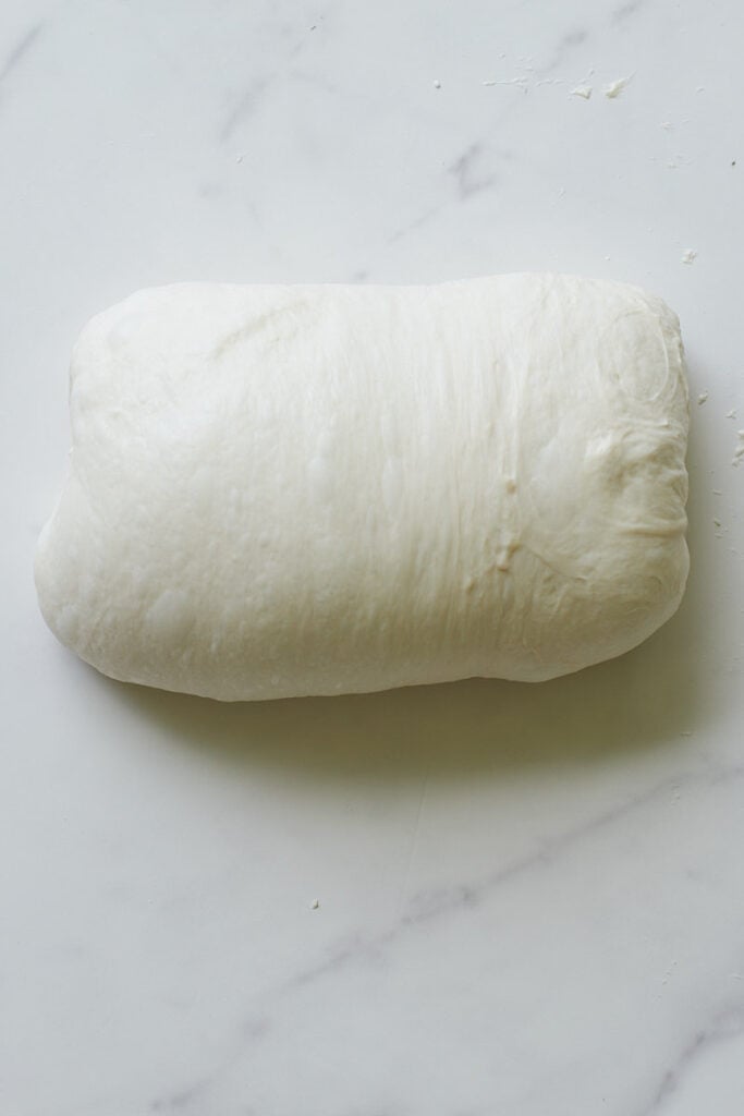 Shaping sourdough bread dough.