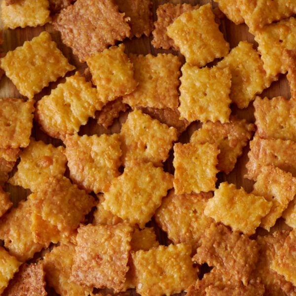 Close up of sourdough cheez-it crackers on a wooden board.