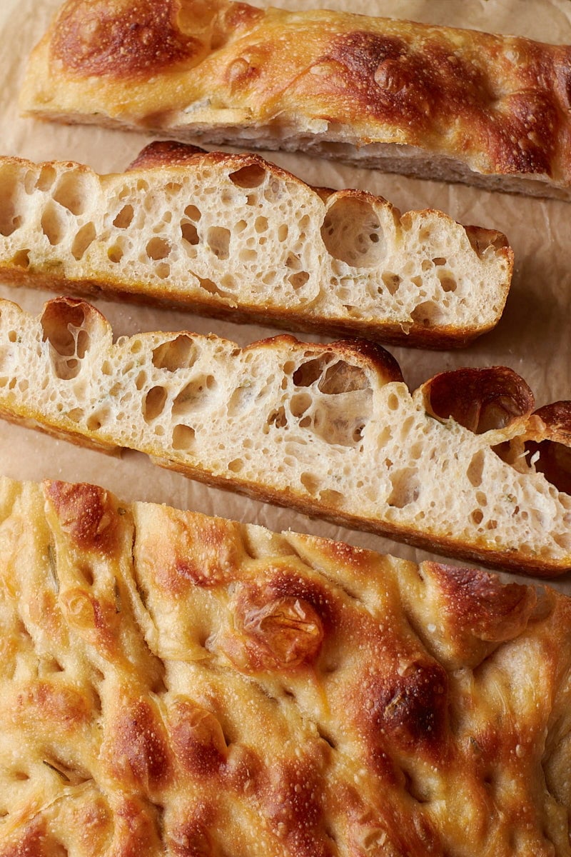 Inside view of sourdough focaccia sliced on top of parchment paper.