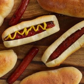 Hot dog with ketchup and mustard on a sourdough bun.