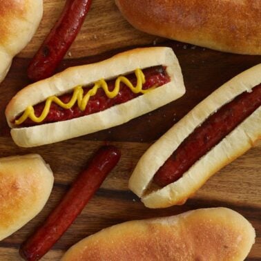 Hot dog with ketchup and mustard on a sourdough bun.