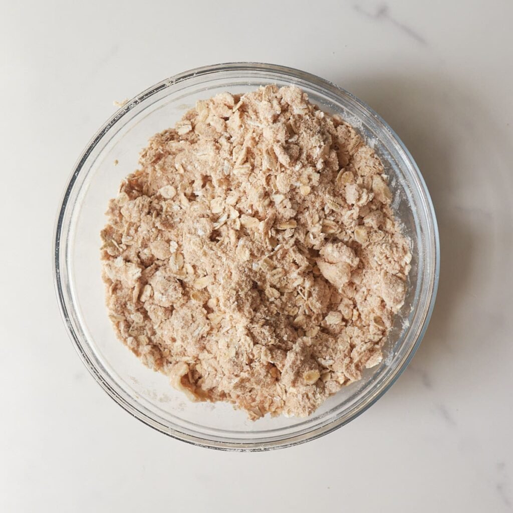 Oat Crisp Topping mixed together in a clear bowl.