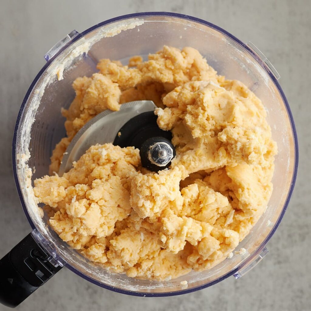 Dough for sourdough cheez-its in a food processor.