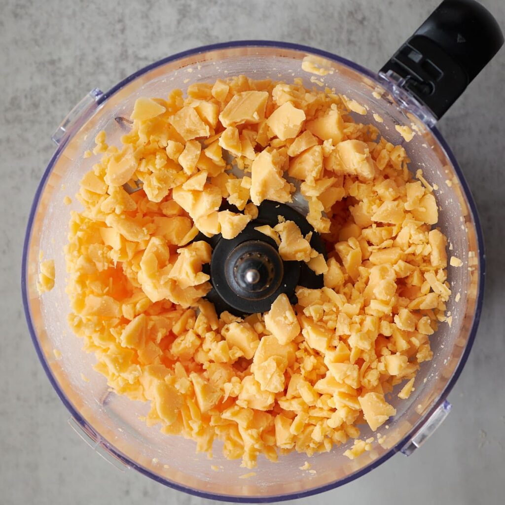Cheddar chopped up into small pieces in a food processor.